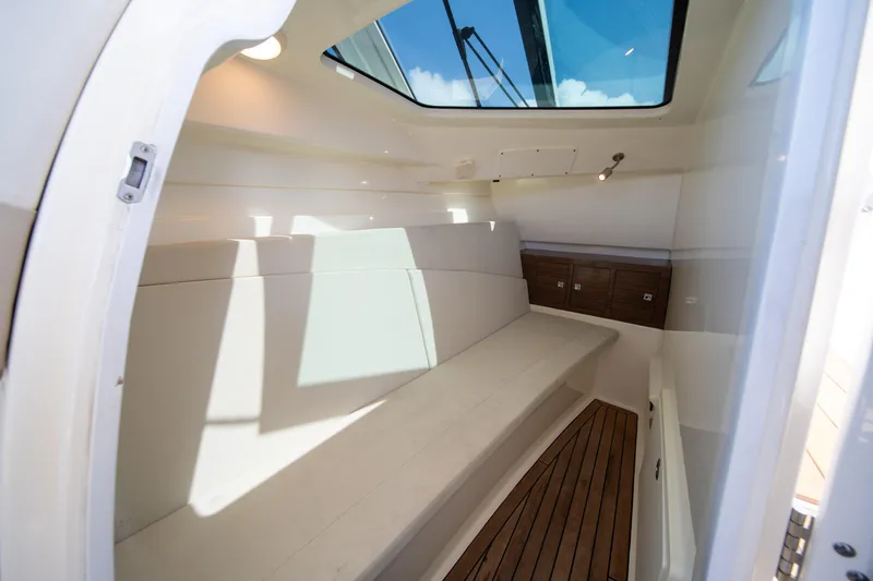 Slide: The Image of Interior cabin of 2018 Boston Whaler 320 Vantage with skylight and wooden flooring. - 32
