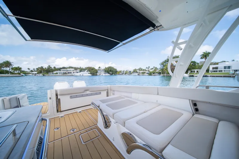 Slide: The Image of 2018 Boston Whaler 320 Vantage boat interior with waterfront view, featuring comfortable seating. - 37