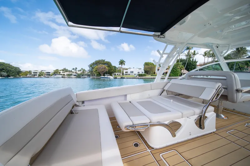 Slide: The Image of 2018 Boston Whaler 320 Vantage boat interior with seating, overlooking serene waterfront. - 39