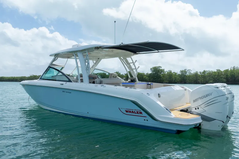 Slide: The Image of 2018 Boston Whaler 320 Vantage boat on calm water, featuring twin Mercury engines. - 4