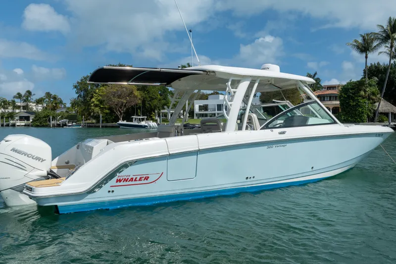 Slide: The Image of 2018 Boston Whaler 320 Vantage boat on water, clear sky, tropical background. - 6