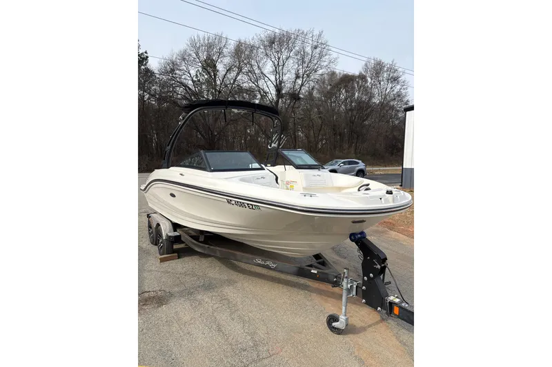 Slide: The Image of 2023 Sea Ray SPX 210 boat on trailer, parked outdoors. - 10