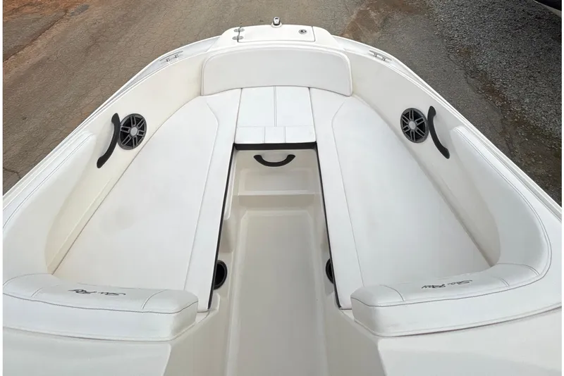 Slide: The Image of 2023 Sea Ray SPX 210 boat interior with white seating and built-in speakers. - 12