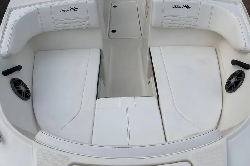Slide: The Image of 2023 Sea Ray SPX 210 boat interior with white seating and speakers. - 13