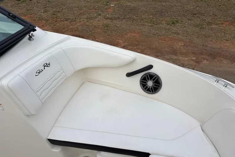Slide: The Image of 2023 Sea Ray SPX 210 boat interior with white seating and speaker. - 14