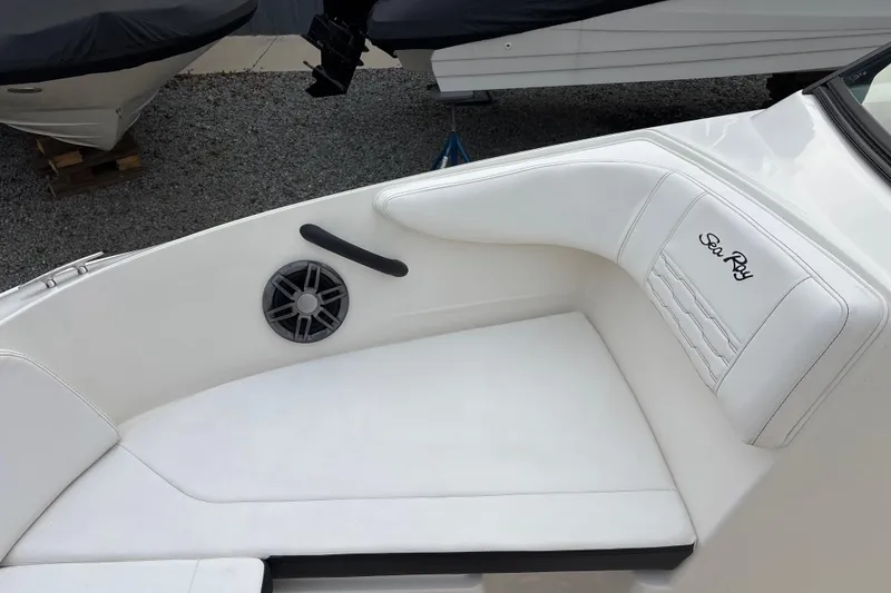 Slide: The Image of 2023 Sea Ray SPX 210 boat interior with white seating and speaker. - 15