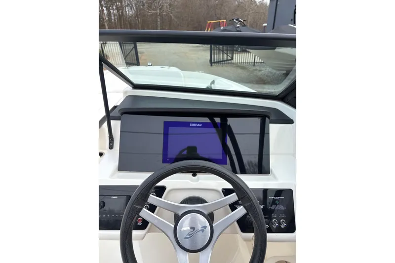 Slide: The Image of 2023 Sea Ray SPX 210 dashboard with steering wheel and Simrad display. - 20