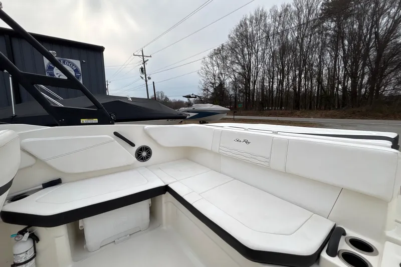 Slide: The Image of 2023 Sea Ray SPX 210 boat interior with white seating and cup holders. - 22
