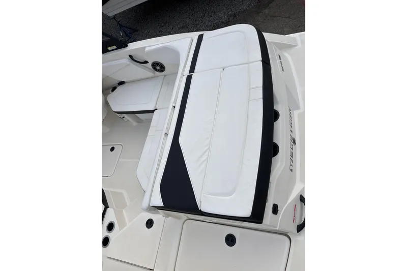 Slide: The Image of 2023 Sea Ray SPX 210 boat interior with white cushioned seating and speaker. - 24