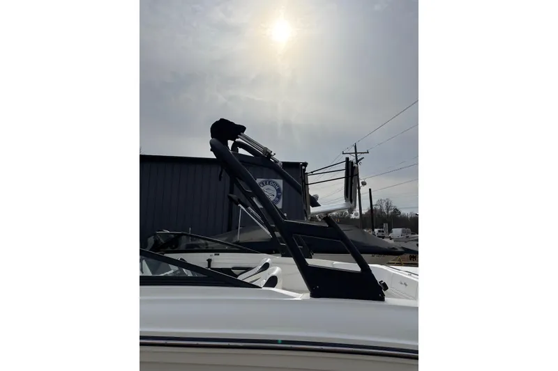 Slide: The Image of 2023 Sea Ray SPX 210 boat with wakeboard tower under a cloudy sky. - 5