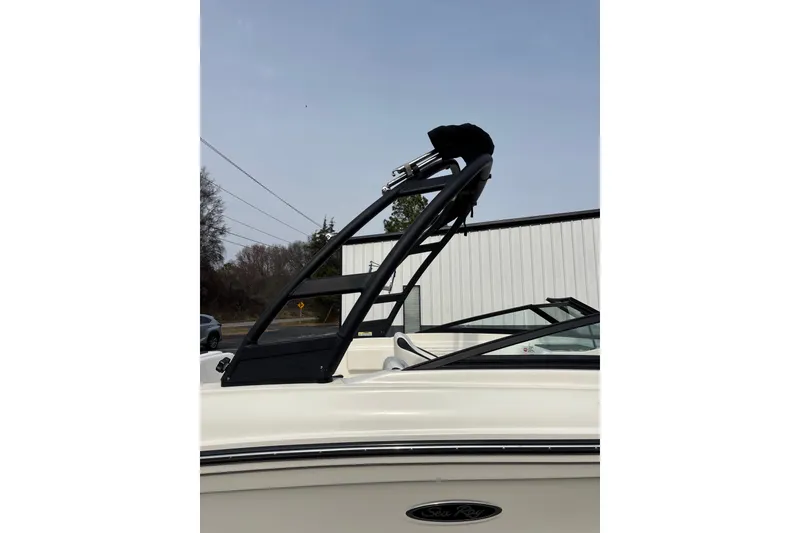 Slide: The Image of 2023 Sea Ray SPX 210 boat with sleek black tower against clear sky. - 9