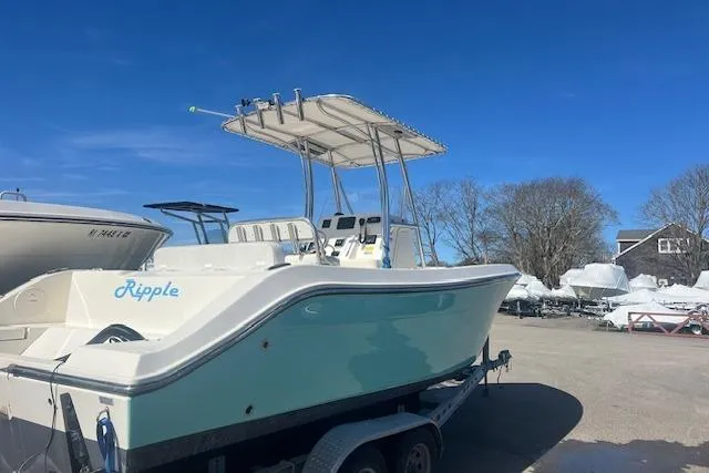 Slide: The Image of 2021 Cobia 237 Center Console boat on trailer, clear sky background. - 2