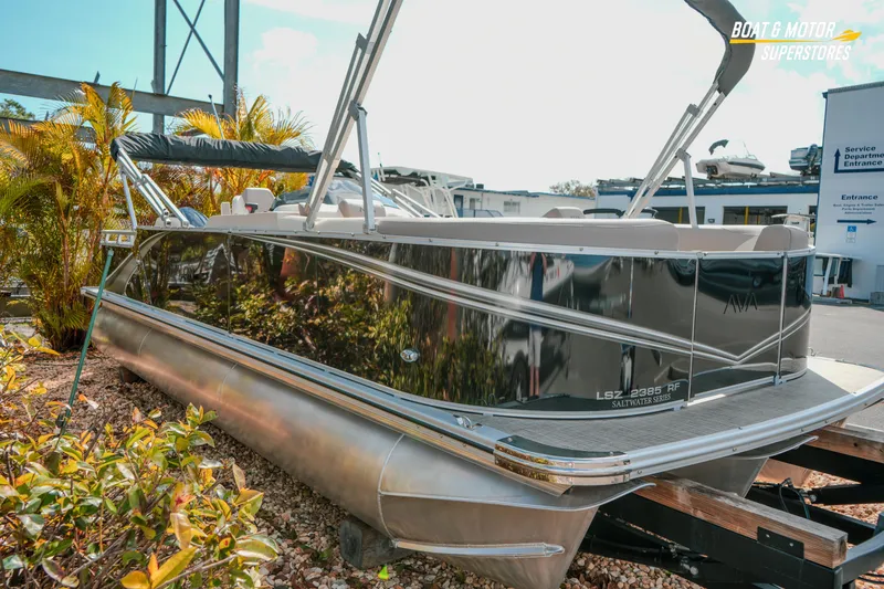 Slide: The Image of 2026 Avalon LSZ Rear Fish 23' pontoon boat displayed outdoors. - 10