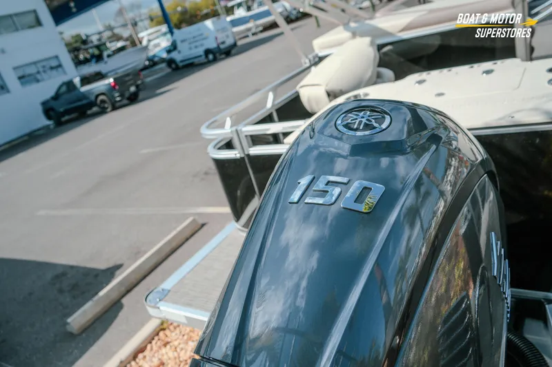 Slide: The Image of 2026 Avalon LSZ Rear Fish boat with Yamaha 150 outboard motor at dealership. - 14