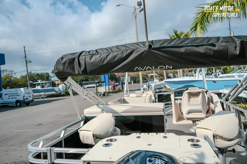 Slide: The Image of 2026 Avalon LSZ Rear Fish boat at dealership, showcasing seating and canopy. - 17
