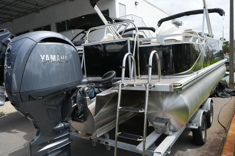 Slide: The Image of 2026 Avalon LSZ Rear Fish boat with Yamaha engine, parked on a trailer. - 21