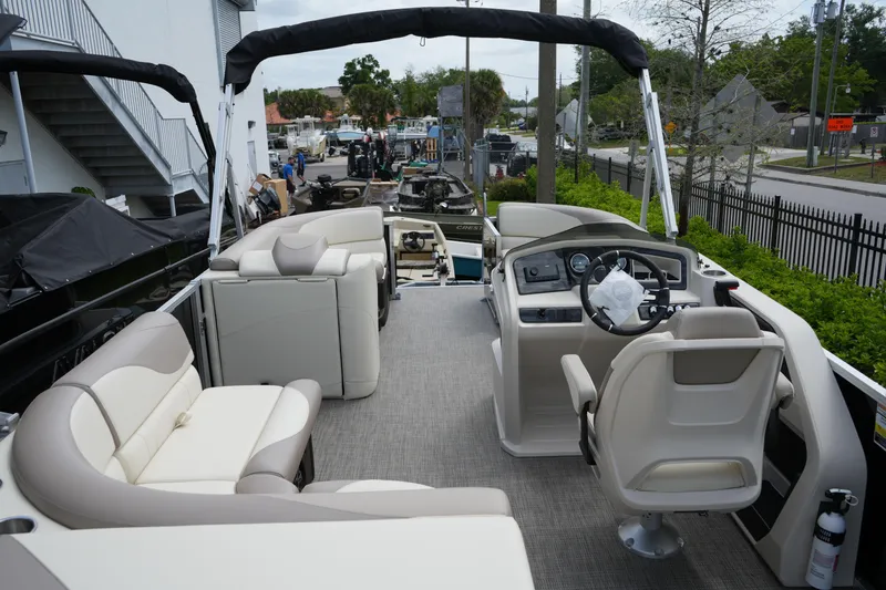 Slide: The Image of 2026 Avalon LSZ Rear Fish 23' pontoon boat interior with helm and seating. - 23