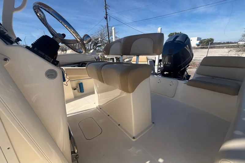 Slide: The Image of 2022 Scout 195 Sportfish boat interior with seating and steering wheel. - 11