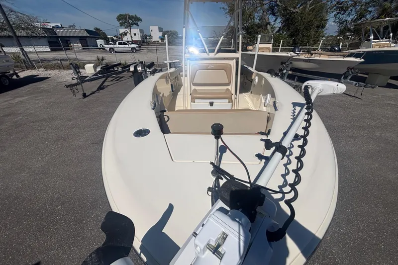 Slide: The Image of 2022 Scout 195 Sportfish boat in a parking lot, showcasing its deck and equipment. - 12