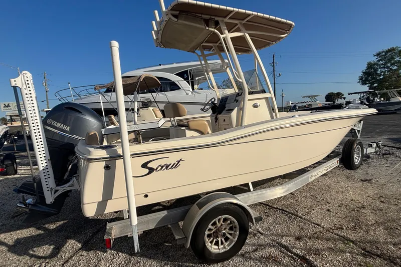 Slide: The Image of 2022 Scout 195 Sportfish boat on trailer, featuring Yamaha engine, parked outdoors. - 4