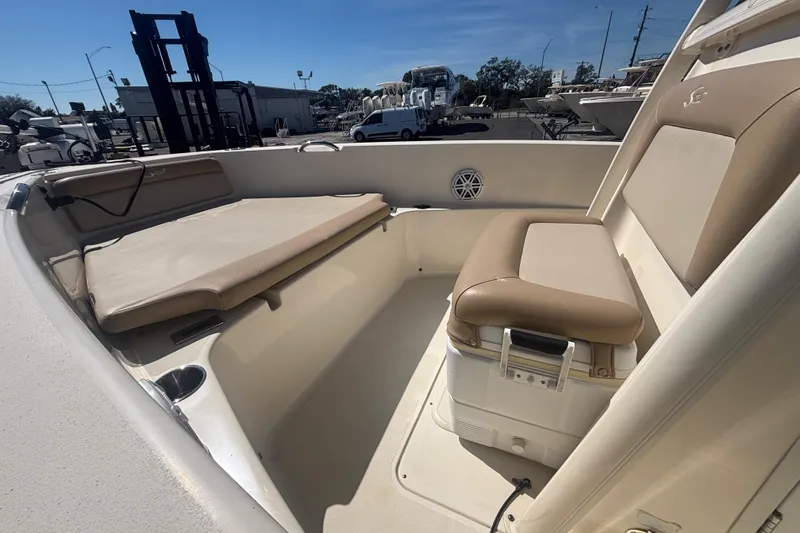 Slide: The Image of 2022 Scout 195 Sportfish boat interior with beige seating and storage area. - 6
