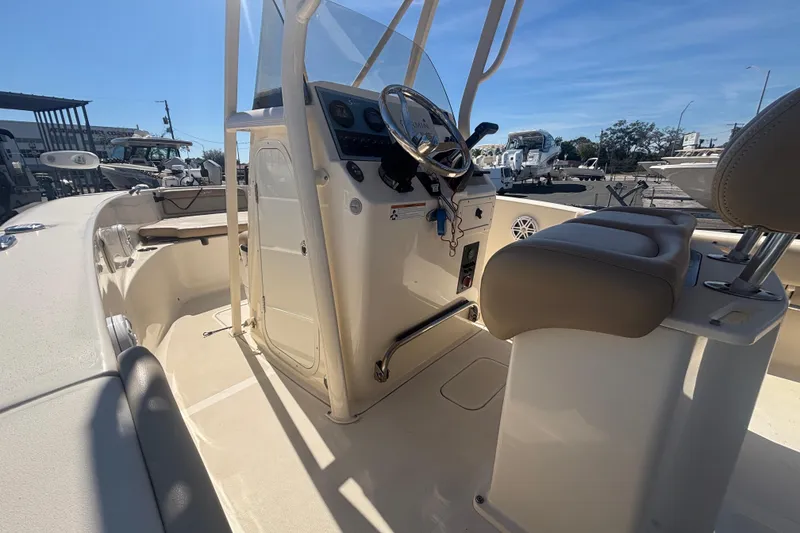 Slide: The Image of 2022 Scout 195 Sportfish boat interior with steering console and seating. - 7