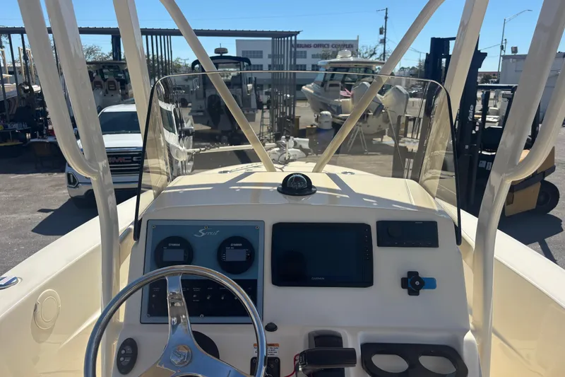 Slide: The Image of 2022 Scout 195 Sportfish boat dashboard with steering wheel and navigation equipment. - 8