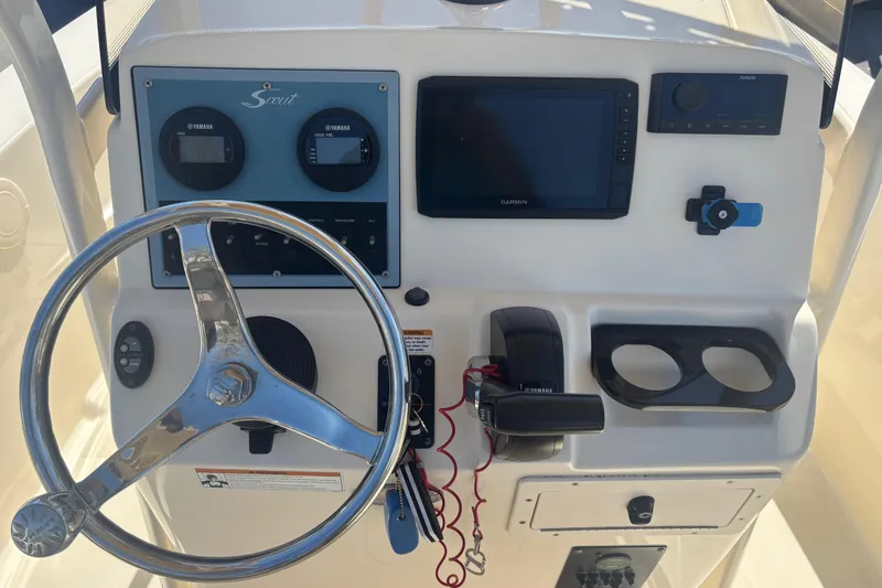 Slide: The Image of Control panel of 2022 Scout 195 Sportfish boat with steering wheel and navigation system. - 9