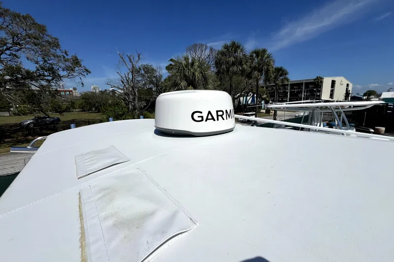Slide: The Image of 2025 Contender 25 Tournament boat with Garmin radar, docked under clear blue sky. - 14