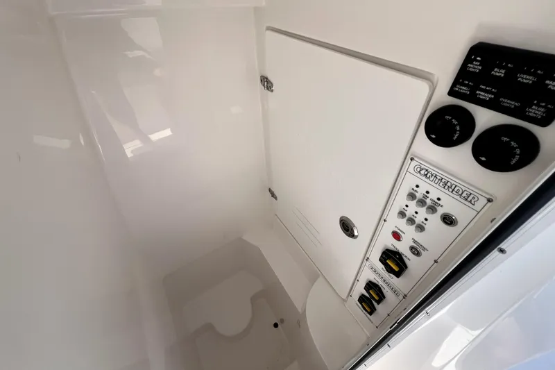 Slide: The Image of Control panel inside 2025 Contender 25 Tournament boat, featuring switches and gauges. - 15
