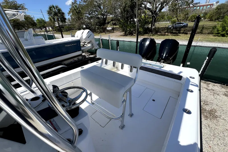 Slide: The Image of 2025 Contender 25 Tournament boat interior with dual engines and steering console. - 16