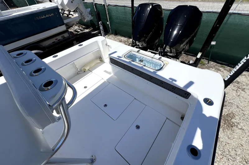 Slide: The Image of 2025 Contender 25 Tournament boat deck with dual outboard motors and rod holders. - 17