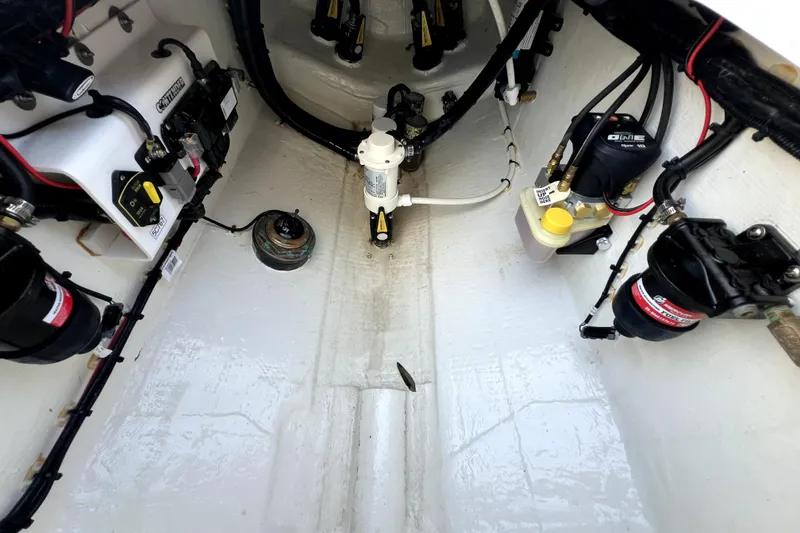 Slide: The Image of Interior view of 2025 Contender 25 Tournament boat's engine compartment with wiring and components. - 19