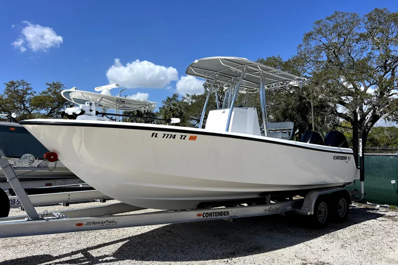 Slide: The Image of 2025 Contender 25 Tournament boat on trailer under clear blue sky. - 2