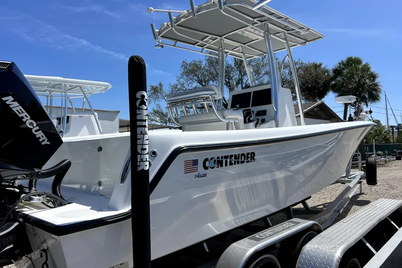 Slide: The Image of 2025 Contender 25 Tournament boat on trailer, featuring sleek design and Mercury engine. - 3