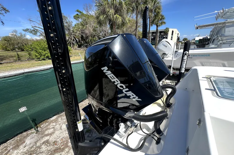 Slide: The Image of 2025 Contender 25 Tournament boat with dual Mercury outboard engines, docked outdoors. - 4