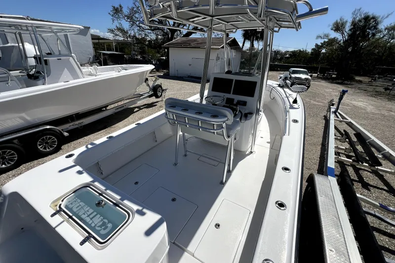Slide: The Image of 2025 Contender 25 Tournament boat with center console and T-top in a sunny outdoor setting. - 6