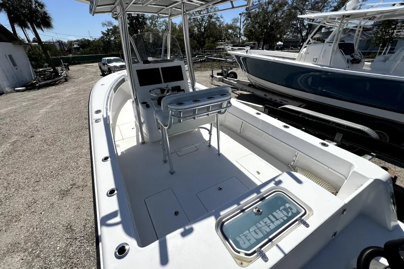 Slide: The Image of 2025 Contender 25 Tournament boat with spacious deck and modern console, parked outdoors. - 7