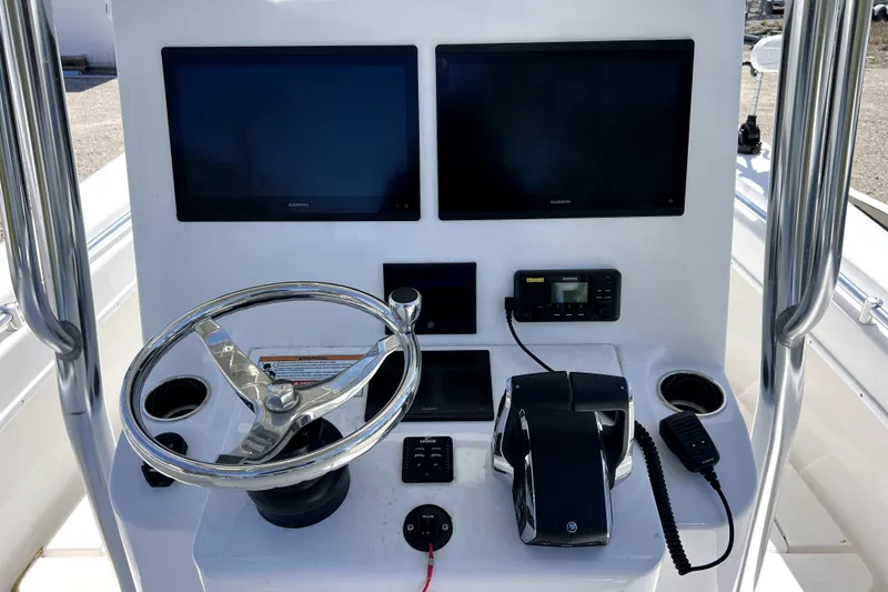Slide: The Image of 2025 Contender 25 Tournament boat console with dual Garmin screens and steering wheel. - 9