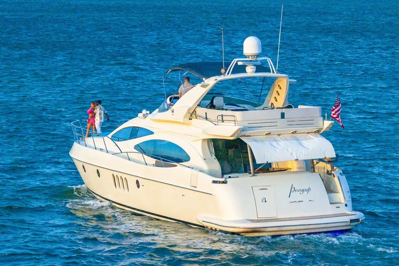Slide: The Image of 2003 Azimut Fly 68 yacht cruising on open water with passengers on deck. - 12