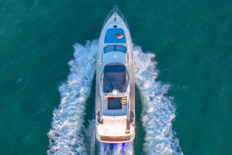 Slide: The Image of Aerial view of 2003 Azimut Fly 68 yacht cruising on open water. - 14