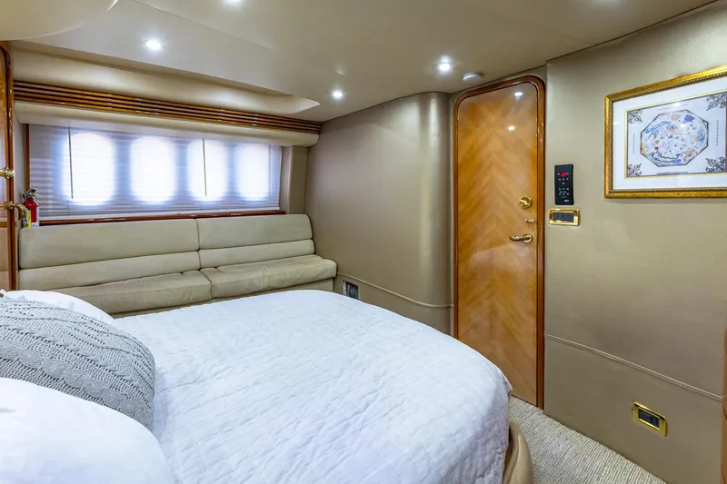 Slide: The Image of Luxurious interior of 2003 Azimut Fly 68 yacht with elegant bedroom and cozy seating. - 24