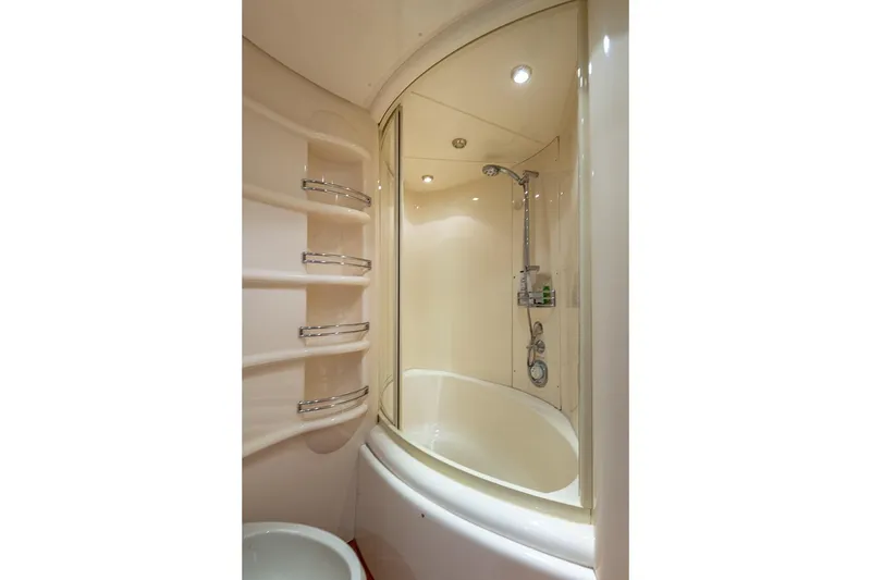 Slide: The Image of Luxurious bathroom in 2003 Azimut Fly 68 yacht with curved shower and shelving. - 27