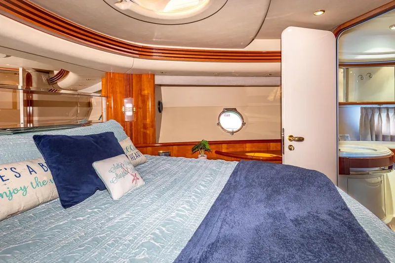 Slide: The Image of Luxurious bedroom interior of 2003 Azimut Fly 68 yacht with elegant bedding and porthole. - 29