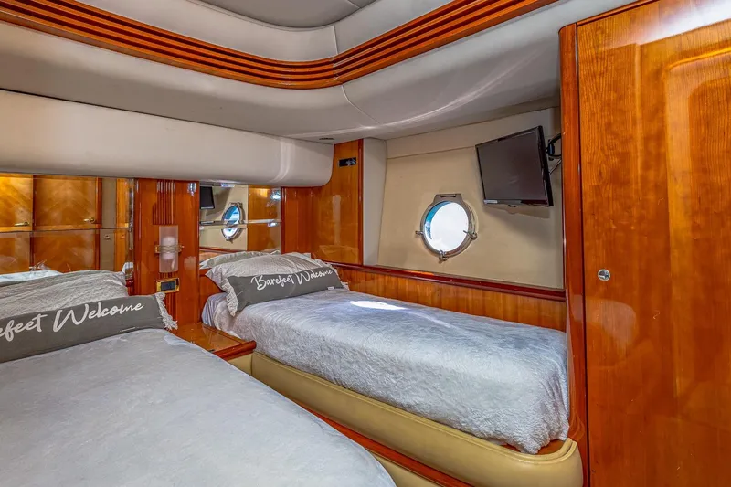 Slide: The Image of Luxurious 2003 Azimut Fly 68 yacht cabin with twin beds and elegant wood finish. - 32