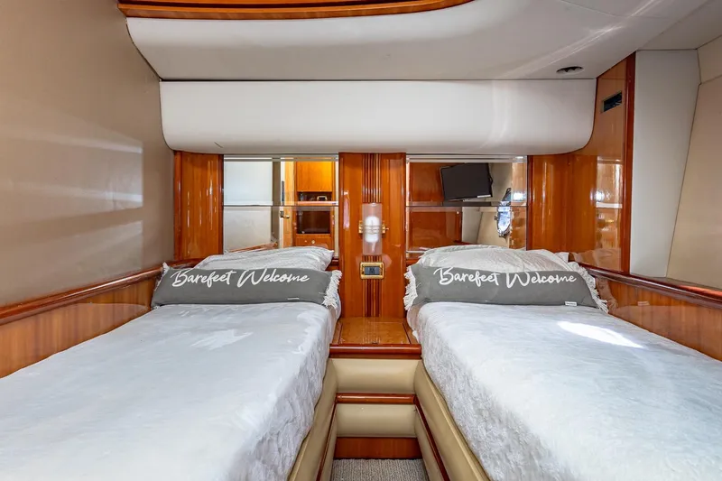 Slide: The Image of Luxurious cabin interior of 2003 Azimut Fly 68 yacht with twin beds and elegant wood finish. - 33
