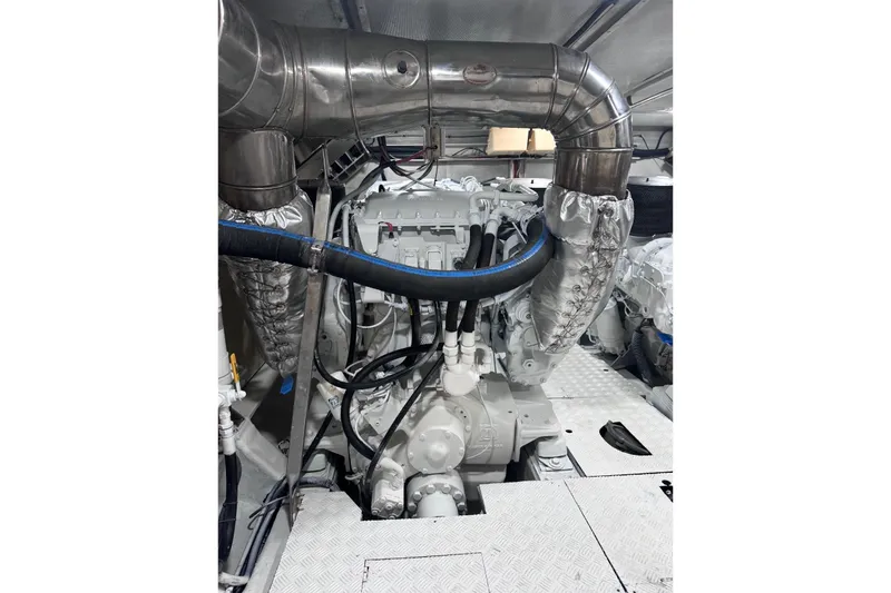 Slide: The Image of Engine room of a 2003 Azimut Fly 68 yacht, featuring complex piping and machinery. - 38