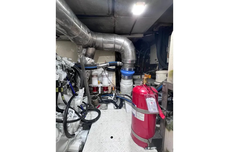 Slide: The Image of Engine room of 2003 Azimut Fly 68 yacht with visible piping and fire extinguisher. - 40