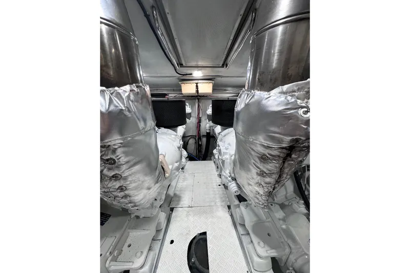 Slide: The Image of Engine room of 2003 Azimut Fly 68 yacht, featuring insulated components and metallic surfaces. - 41