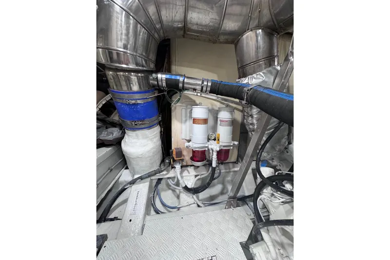Slide: The Image of Engine room of 2003 Azimut Fly 68 yacht, featuring pipes and filtration system. - 43